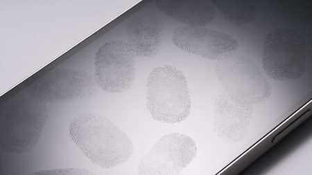 Many Fingerprints on Phone Screen Against White Background High Angle View.