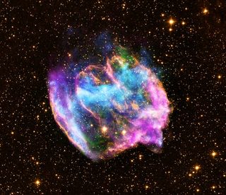 The highly distorted supernova remnant W49B in this image may contain the youngest black hole in the Milky Way galaxy. The image combines X-rays from NASA's Chandra X-ray Observatory in blue and green, radio data from the NSF's Very Large Array in pink, and infrared data from Caltech's Palomar Observatory in yellow. Image released Feb. 13, 2013.