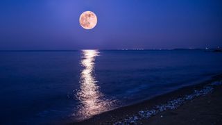 the full moon over the sea