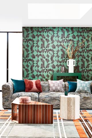 Green living room with green wallpaper and large sofa