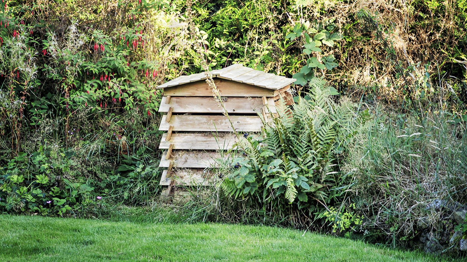 Wooden compost bin shaped like beehive