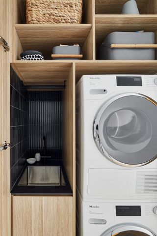 A hidden laundry space inside a cabinet