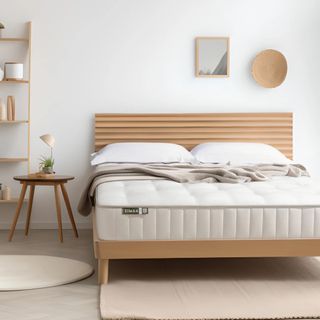 A rendered image of the Simba Earth Source mattress on a wooden bedframe in a rom with wooden accessories