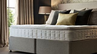 A Hypnos mattress sold by MyNextMattress in pride of place in a cosy bedroom