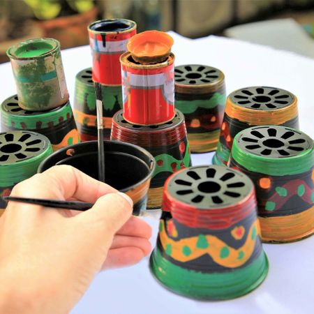 painting old plastic plant pots by hand