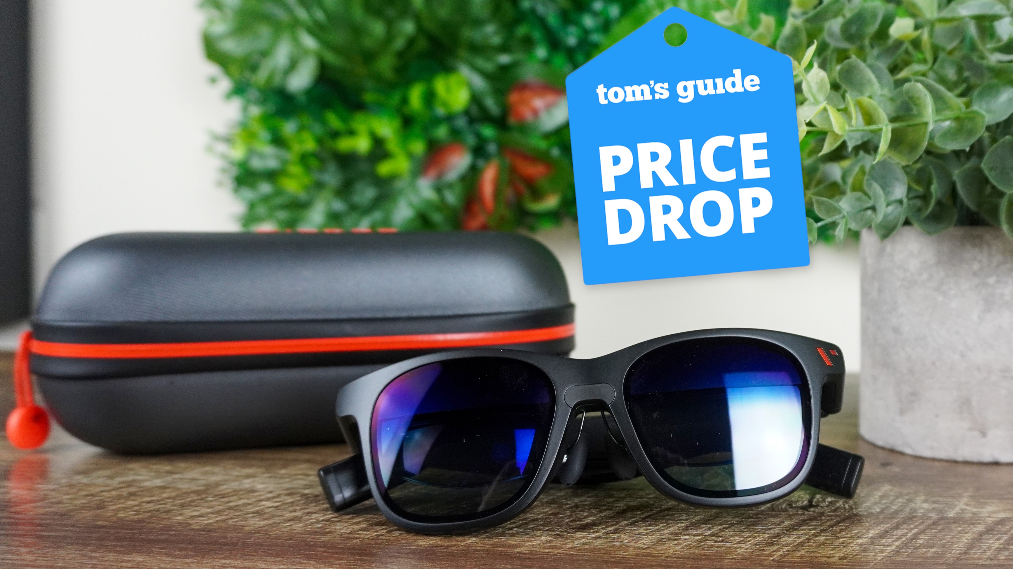 The Viture Pro XR Glasses with their case on a table with a Tom's Guide Price Drop badge on top