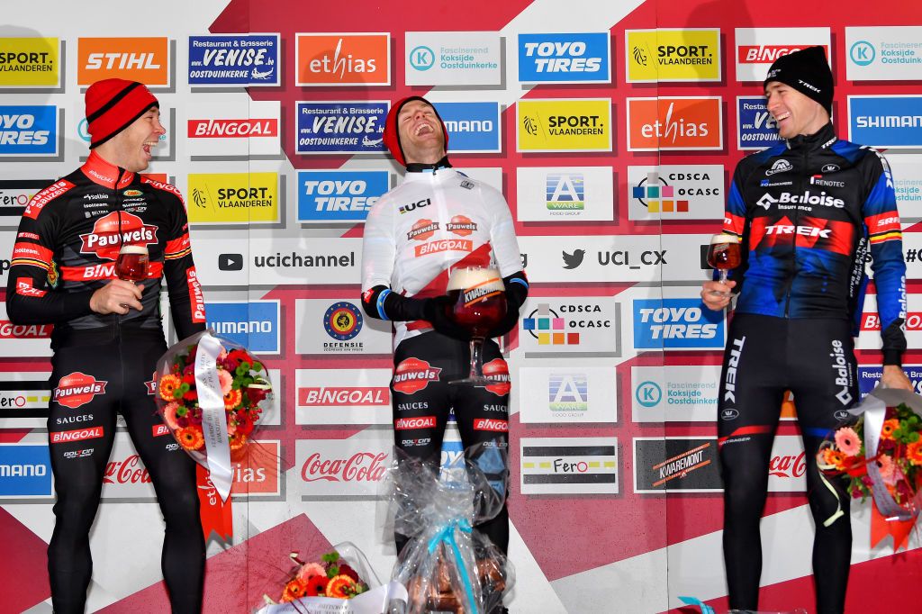 KOKSIJDE BELGIUM NOVEMBER 21 LR Laurens Sweeck of Belgium and Team Pauwels Sauzen Bingoal on second place race winner and leader WorldCup jersey Eli Iserbyt of Belgium and Team Pauwels Sauzen Bingoal and Toon Aerts of Belgium and Team Baloise Trek Lions on third place cheer on the podium during the podium ceremony after the 50th Koksijde UCI CycloCross Worldcup 2021 Mens Elite CXWorldCup on November 21 2021 in Koksijde Belgium Photo by Luc ClaessenGetty Images