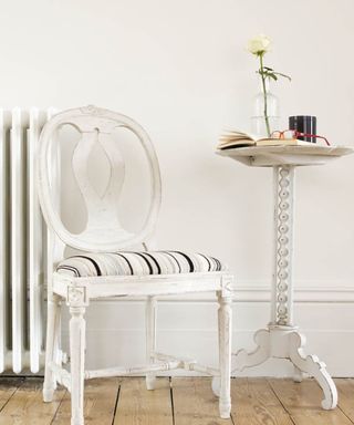 Mylands of London Pure White paint used in a hallway with a chair and a table in it