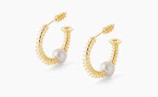 Earrings where the gold screws seem to go straight through a pearl