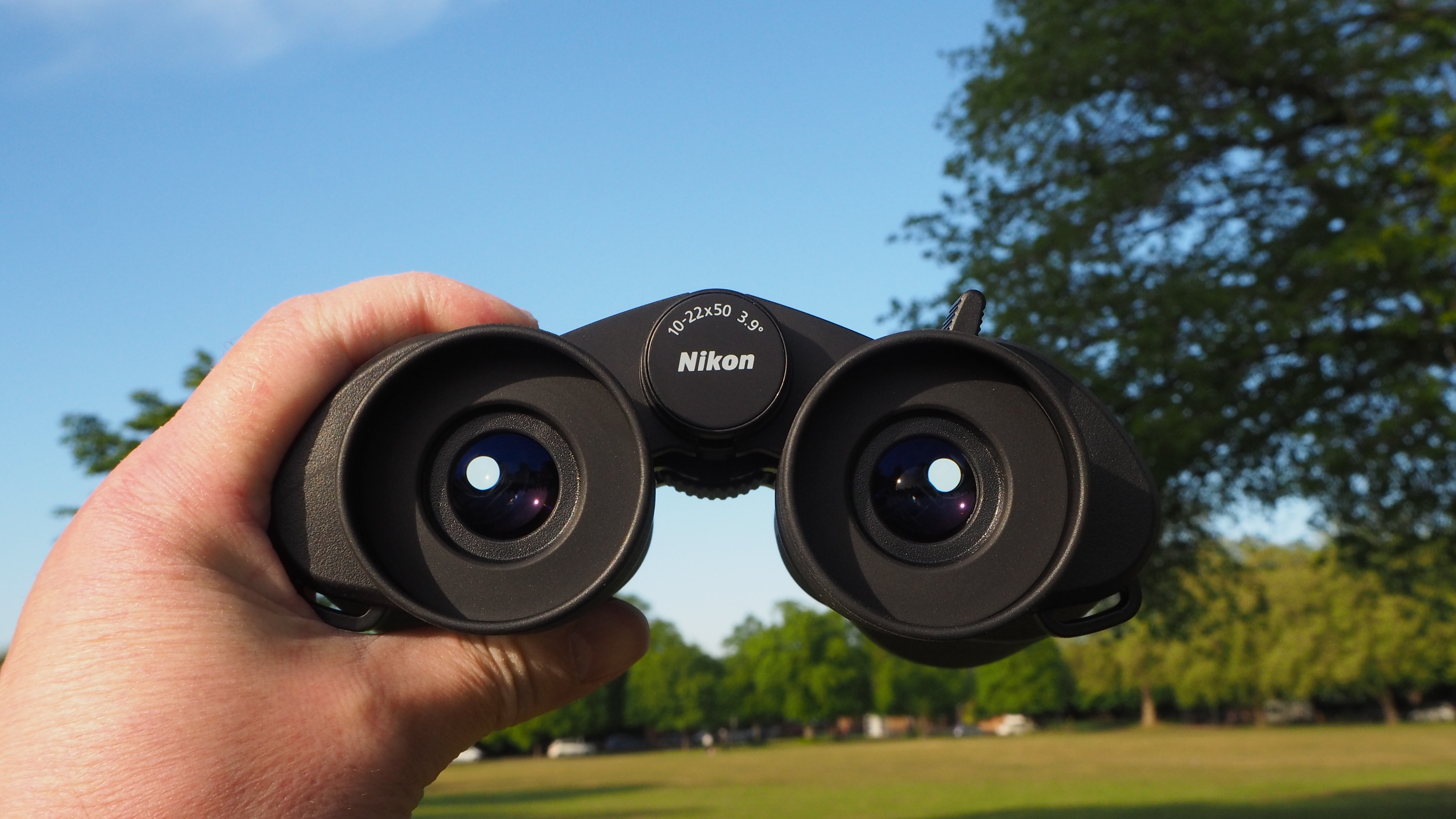 Nikon Action Zoom 10-22x50 binoculars in a person's hands