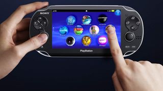 PlayStation Vita being held by left hand, right hand is using the touchscreen