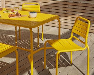 A yellow metal outdoor dining set