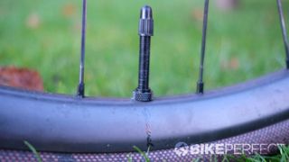 Close up of Scribe Gravel Wide++ rim profile and valve