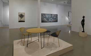 An exhibition hall with table and a chair in the center
