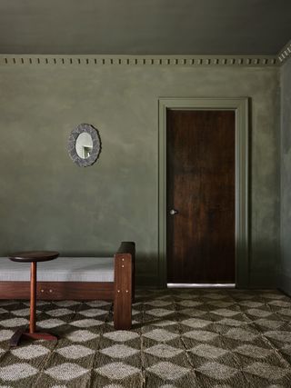 An entrance with the entire room painted in earthy, limewash paint in green tones