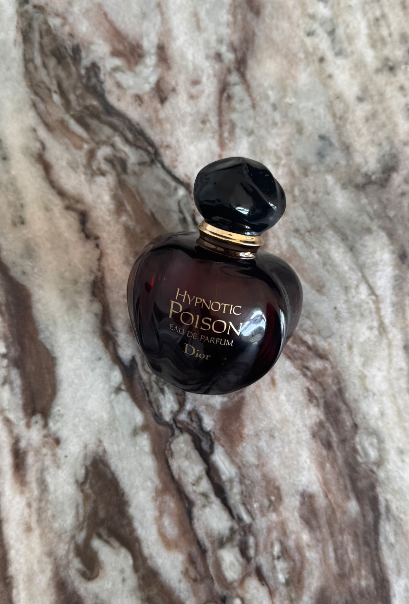 A photo of Dior Hypnotic Poison eau de parfum on a marble table