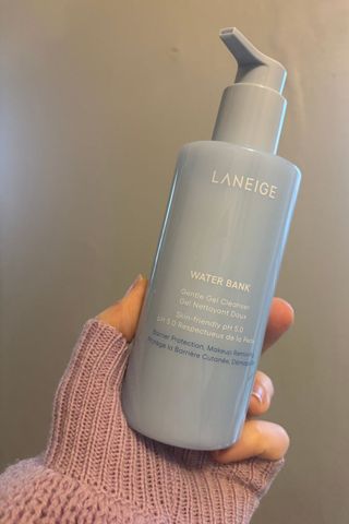 a hand holding laneige water bank cleanser