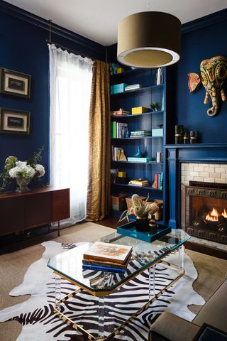 blue office with bookcase and glass table