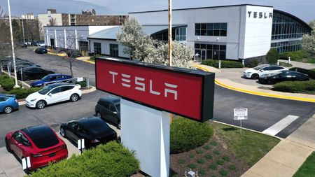 Red Tesla sign outside of Tesla dealership