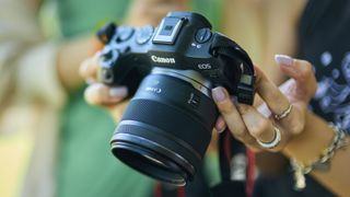 Canon RF 45mm f/1.2 STM on a Canon EOS R8 being held by a photographer