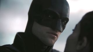 Batman talking to Catwoman in the daylight. 