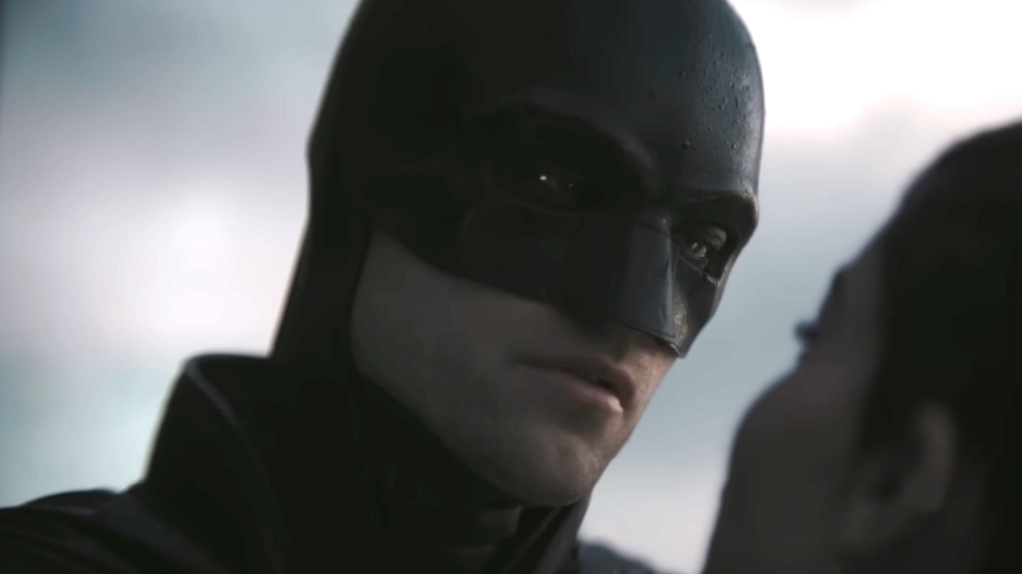 Batman talking to Catwoman in the daylight. 