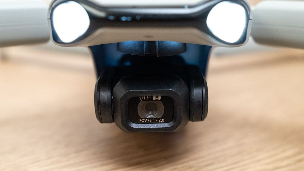 Close up of the camera on a Ruko F11PRO 2 drone on a wooden surface