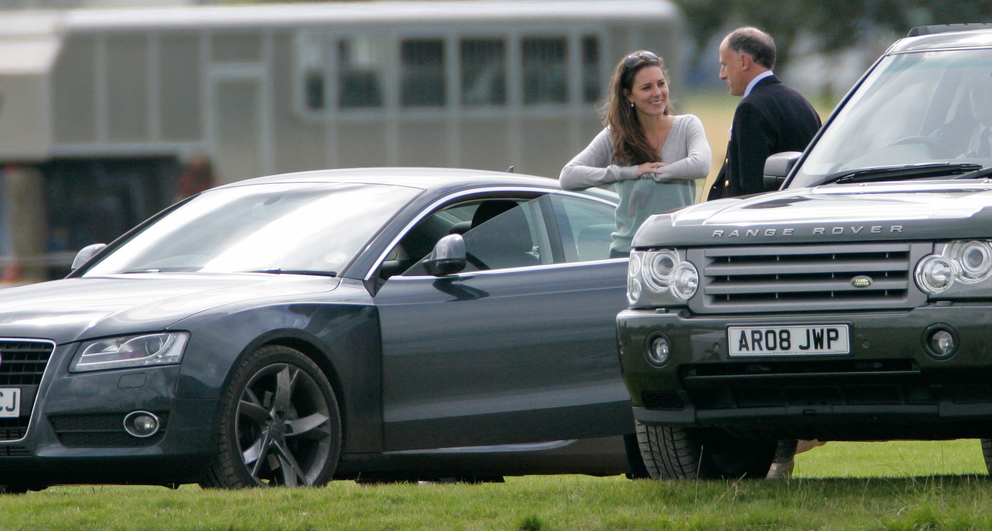 Princess Kate talking to Jamie Lowther-Pinkerton in front of two cars