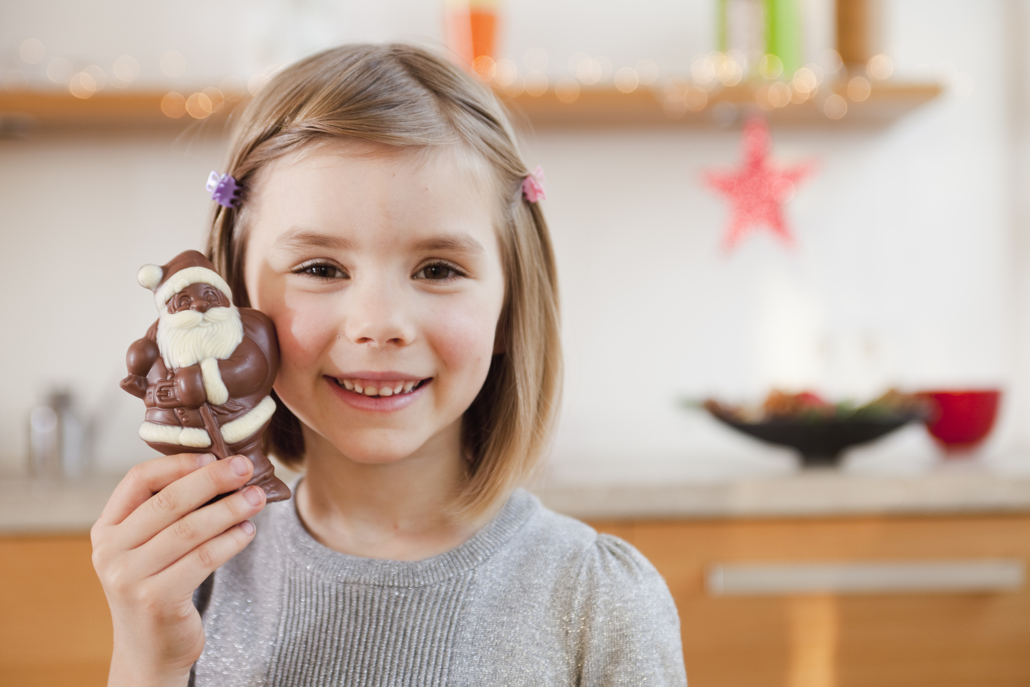 Young girl holding chocolate santa claus