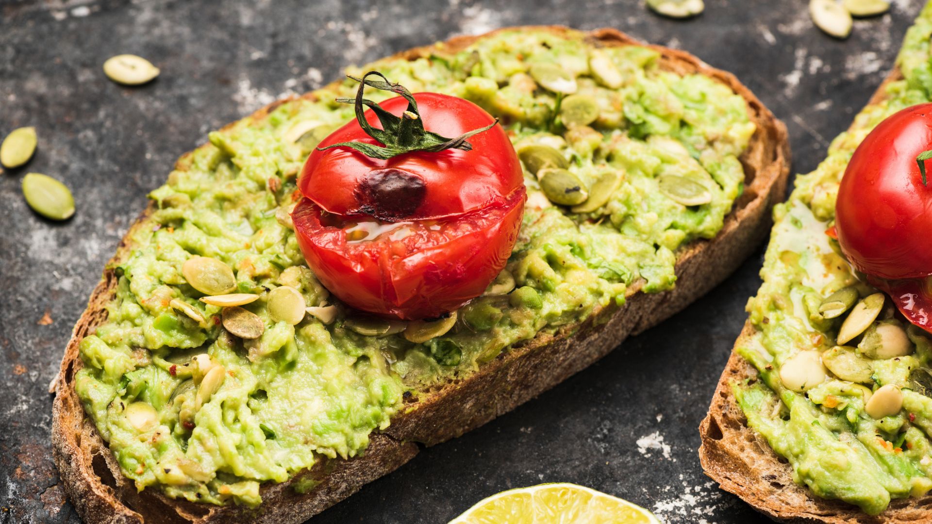 Smashed avocado on toast with a roasted tomato on top