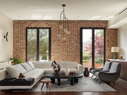 living space with exposed brick at Forest Park House by Javier Robles