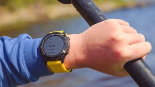 Woman kayaking wearing Garmin Fenix 6 Pro GPS watch