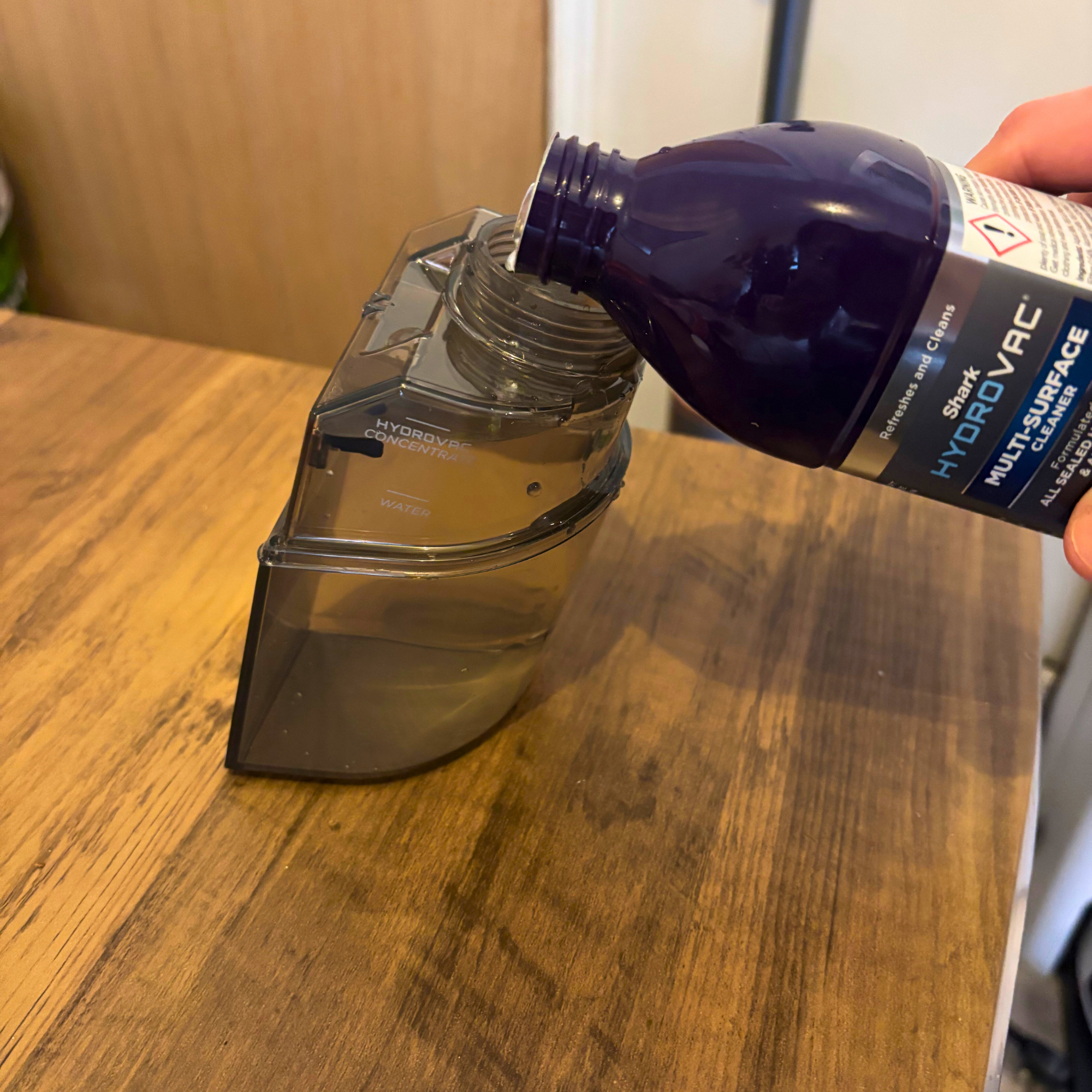 Shark HydroVac Cordless Floor Cleaner clean water tank with cleaning solution being added