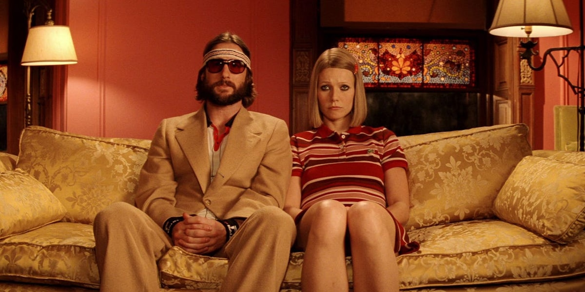 Luke Wilson and Gwyneth Paltrow in The Royal Tenenbaums sat on a sofa