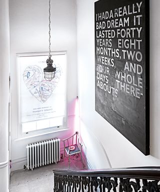 hallway area with eye catching wall art and white walls