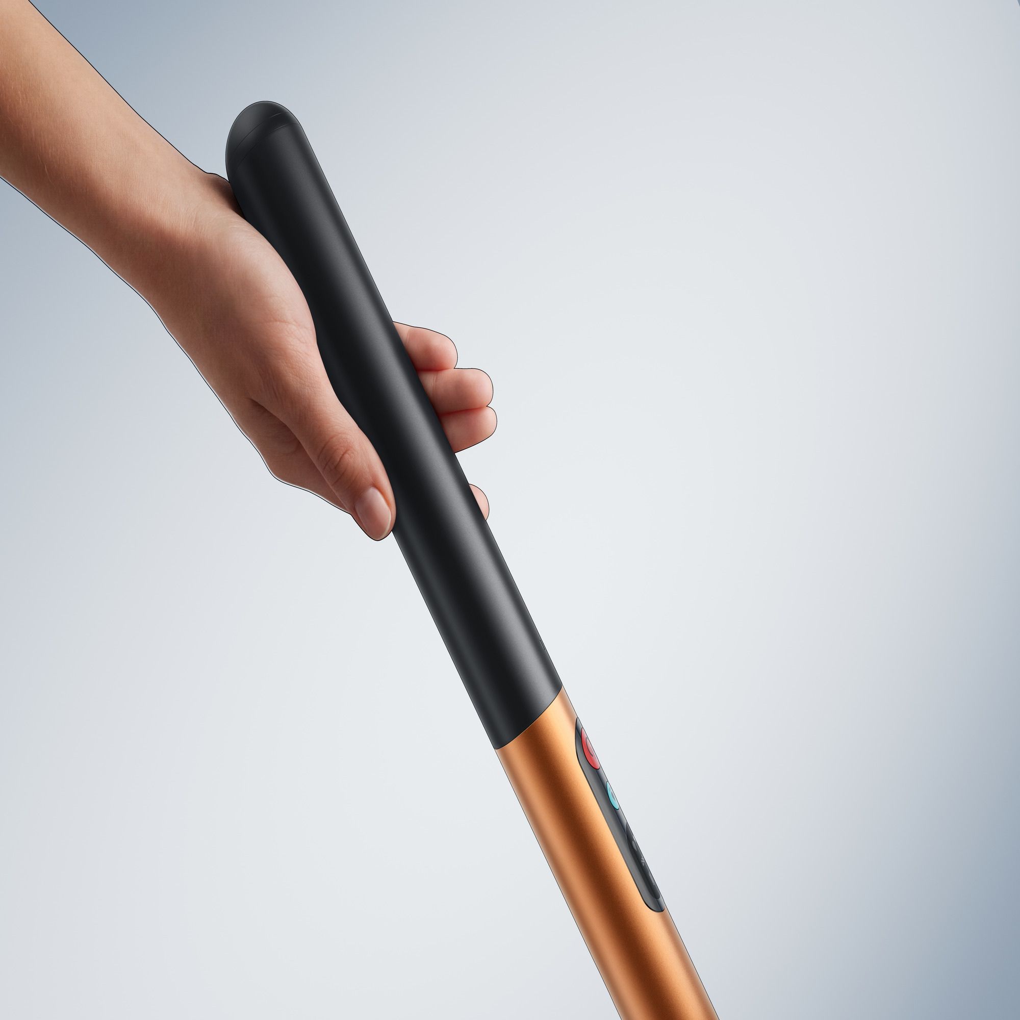 Hand holding the handle of the Dyson PencilWash