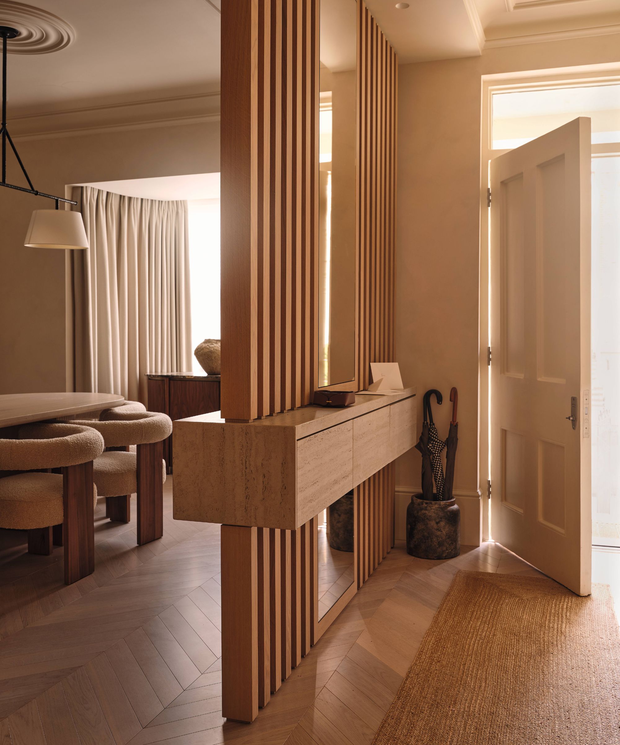 a victorian london home entryway with wab sabi design style, an oak partition leading into a dining room