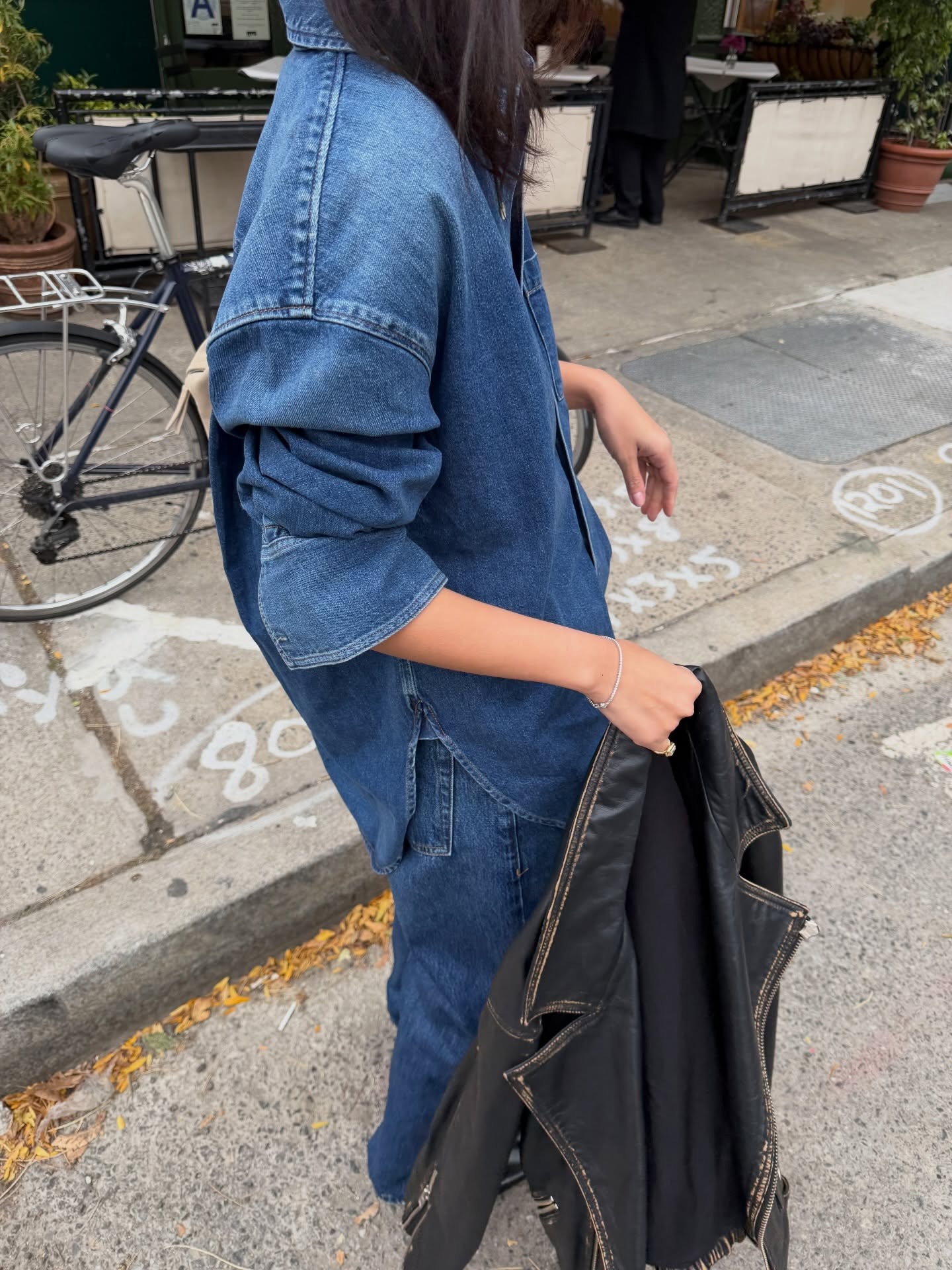 @mimixn wearing a denim shirt and matching jeans with a leather jacket.