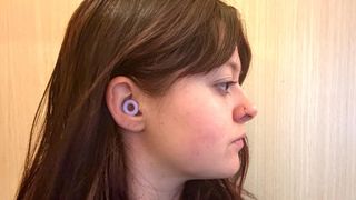 A side on view of a tester wearing the Purple Loop Earplugs