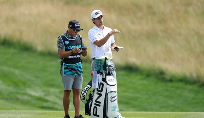 Joaquin Niemann speaks to his caddie