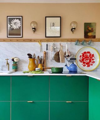 A two-toned kitchen by Farrow and Ball using Setting Plaster pink shade on walls and green paint on kitchen cabinetry