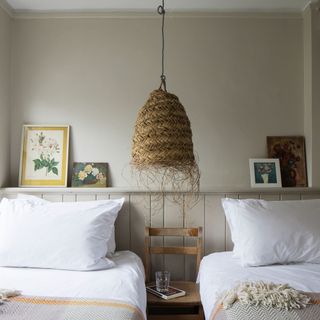 Twin bedroom with wall panelling and natural ceiling pendant