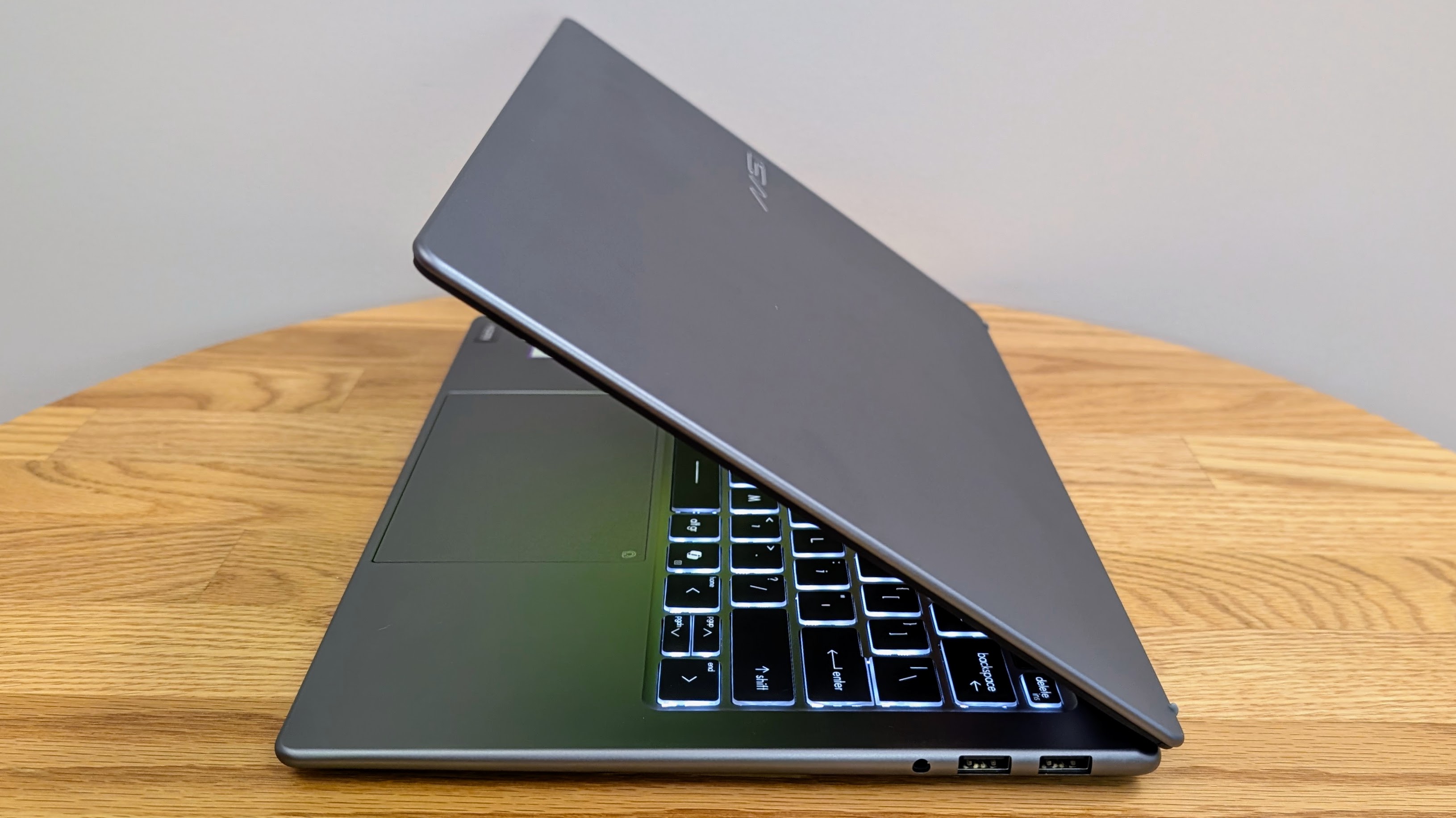 MSI Prestige 14 AI+ half closed on a coffee table