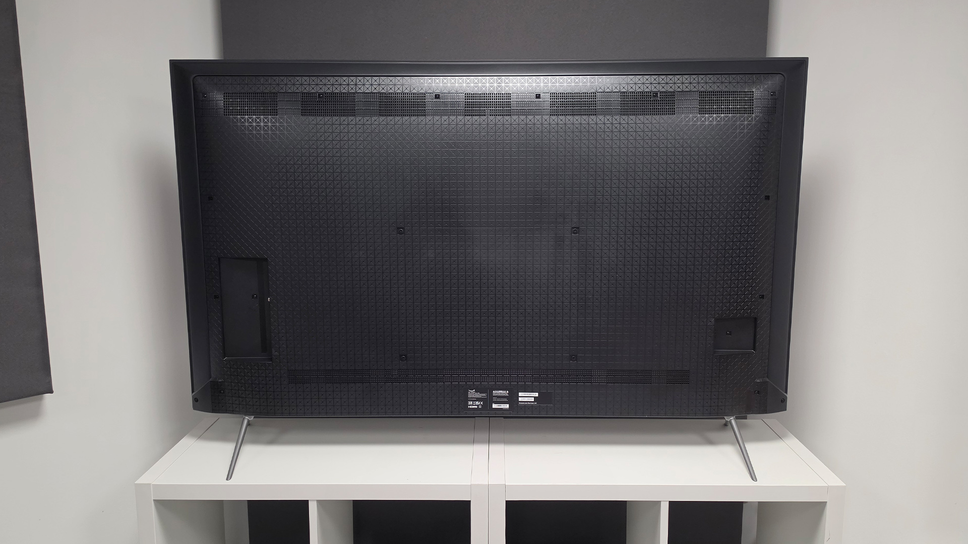 Amazon Fire TV Omni QLED (65-inch) QLED TV, rear of set on white shelving unit