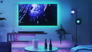Nanoleaf Essentials Lightstrip in use behind a TV in a living room setting.