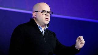 A telephoto shot of Jeff Lawson, the Twilio CEO, speaking at a conference against a blue background