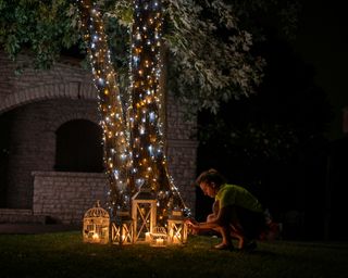 LED lights on tree and lanterns around tree