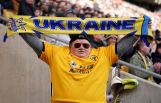 A fan holding a Ukraine scarf