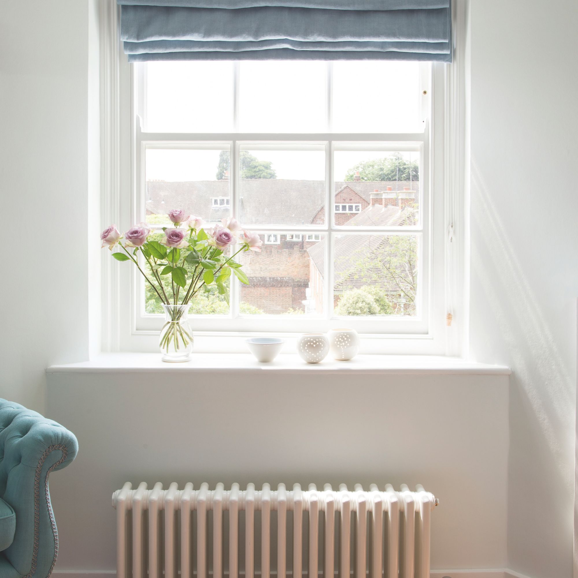 Window with blue blinds and a radiator below it