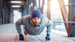 Six ways to keep exercising in winter: image of man doing a press up